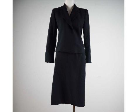 This elegant black two-piece skirt suit by MaxMara is expertly tailored in Italy from 100 percent virgin wool and features a 