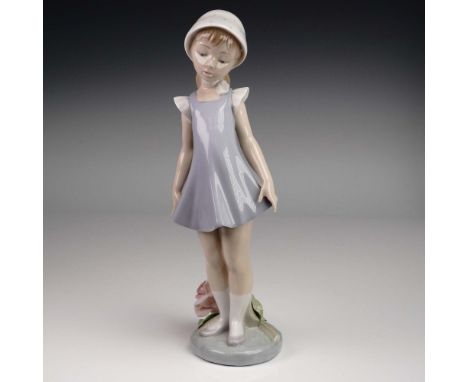 This Lladro porcelain figurine, model 01005039 titled Candid, features a young girl in a flared lavender dress and white bonn