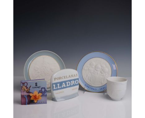 This lot comprises two limited-edition annual LladrÃ³ Christmas plates titled Navidad, presented alongside an original LladrÃ