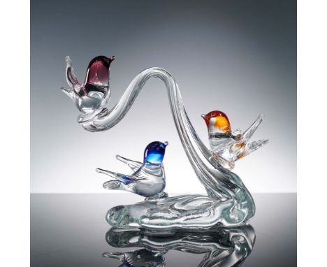Handcrafted clear art glass sculpture featuring three colorful birds in flight, perched across a gracefully arched base. This