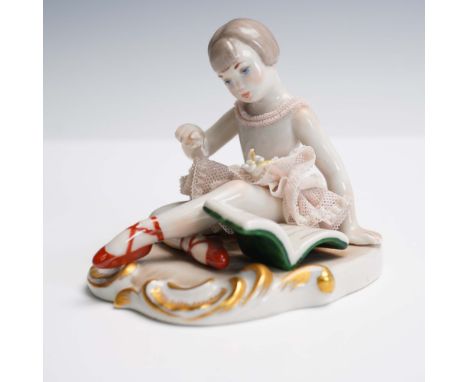 This charming Lladro porcelain figurine depicts a seated girl thoughtfully reading an open book and showcases the delicate la