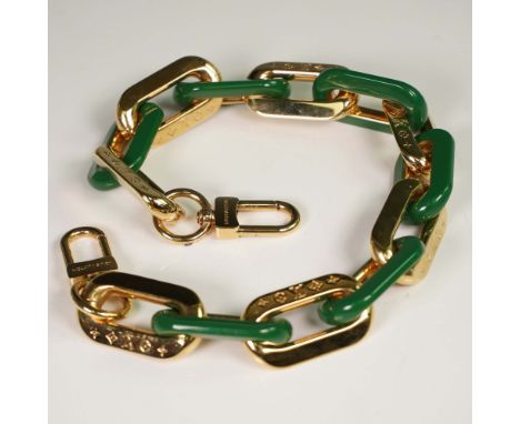 Louis Vuitton designer bag charm featuring alternating green resin and gold-tone metal chain links, some engraved with the LV