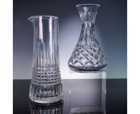 This refined two-piece Waterford crystal set includes a wide-bodied wine carafe and a tall pitcher, each showcasing signature