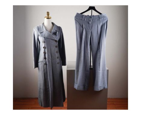 This vintage-inspired two-piece ensemble by Biba features a striking blue Maxi coat with a dramatic double-breasted button fr