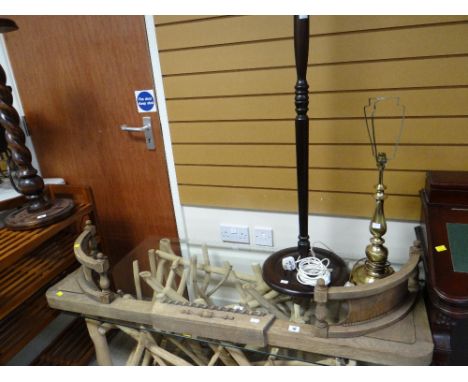 A brass effect table lamp, a standard lamp and a wooden fender