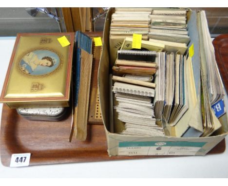A collection of vintage holiday tourist photographs & guides, coronation tin, cribbage board etc