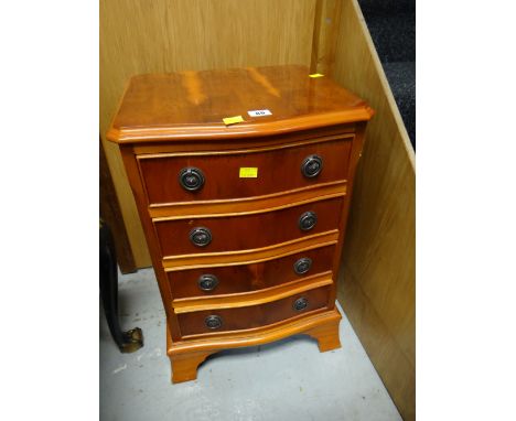 A small reproduction walnut bow fronted four-drawer chest / lamp table