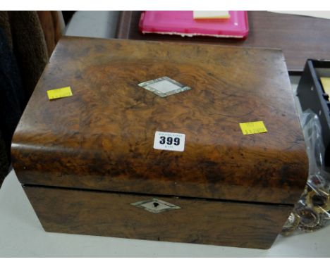 A vintage walnut and mother-of-pearl inlaid travel box and contents