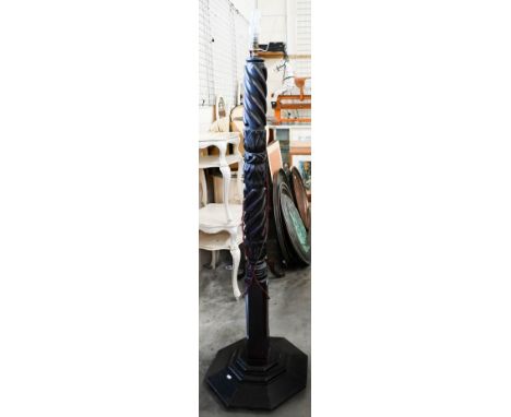 An antique mahogany standard lamp with spiral reeded carved column on octagonal platform base, 150 cm high 