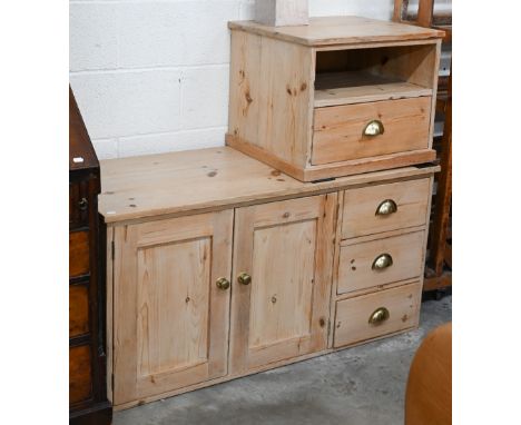 A stripped pine side cabinet with panelled doors and three drawers with brass handles, 122 x 30 x 60 cm h to/w a matching lam