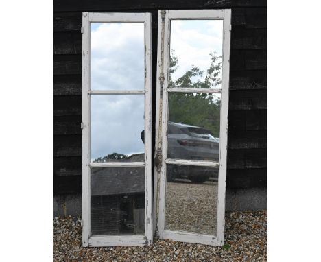 A pair of vintage reclaimed French chateau three pane hardwood windows, in remnants of original painted finish and iron espan