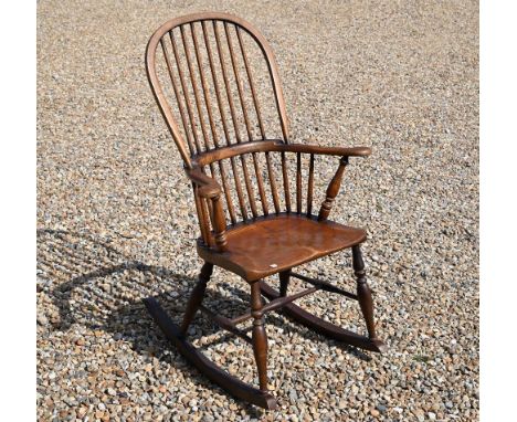 A traditional stained ash and elm stick-back rocking elbow chair 