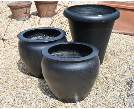 A large black surface finished terracotta planter 70 cm dia. x 73 cm h to/with a smaller pair 57 cm dia. x 50 cm h (3)2 small