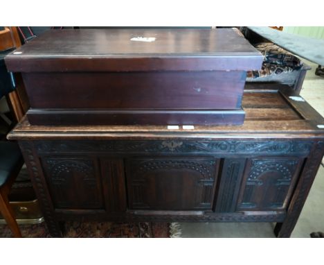 A carved oak panelled coffer 118 x 44 x 60 cmh to/w a trunk (2) 