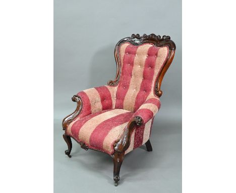 A late Victorian rosewood show framed salon chair, with later button upholstered covers, the front legs raised on brass casto