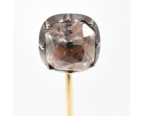 A 19th century Georgian gold black dot quartz stick pin. The stick pin mounted with a collet set quartz having a black dot cu