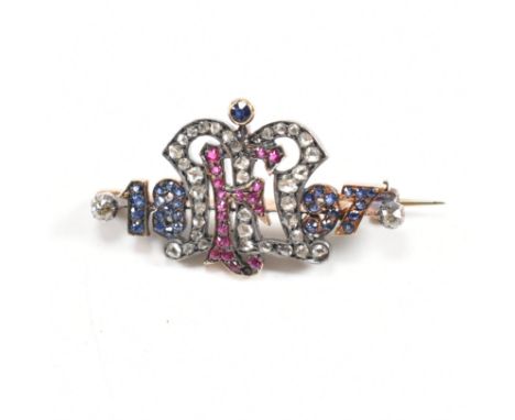 A 19th century Victorian ruby sapphire and diamond brooch pin. The brooch with central crown and monogram letter F centre. Fl