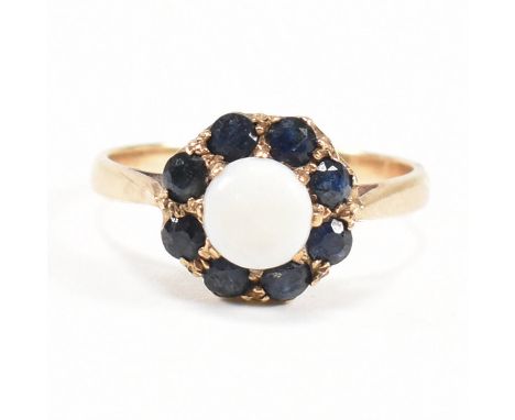 A gold sapphire and opal cluster ring. Marks rubbed tests as 9ct gold. Weight 2.6g. Size N.&nbsp;All weights, measurements an