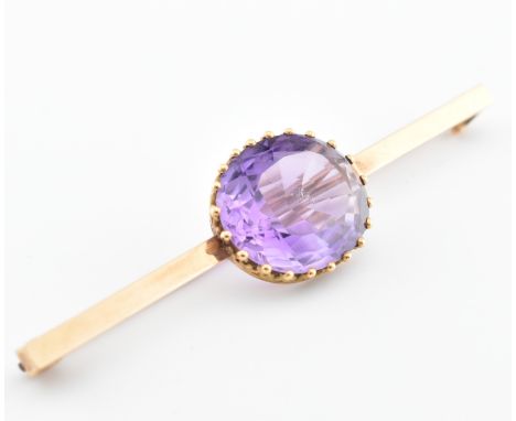 A 15ct gold and amethyst bar brooch. The bar brooch set with a large 15ct amethyst to centre. Pin verso. Raised 15 mark to pi