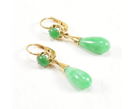 A pair of gold and jade pendant earrings. The earrings strung with jade drops surmounted by claw mounted jade cabochons to le