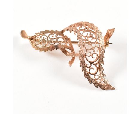 A hallmarked 1970s 9ct rose gold brooch pin. The brooch in the form of entwined leaves having roller clip clasp verso. Hallma