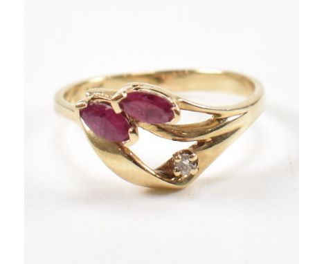 A 14ct gold ruby and diamond ring. The ring with two ruby stones accented by diamonds. Weight 2.2g. Size M.&nbsp;All weights 