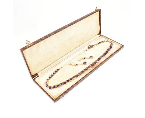 An Edwardian 9ct gold rivi&egrave;re necklace and earring suite. The necklace consisting of graduating collet set round cut a