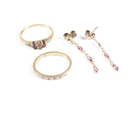 Two hallmarked 9ct gold rings and a pair of gold and gem set earrings. The rings including a ruby and diamond stepped five st