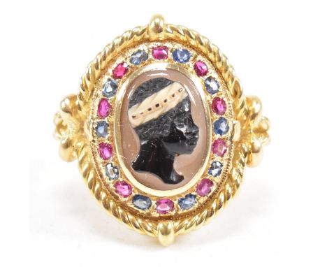 An 18ct gold blackamoor agate cameo ruby and sapphire cameo ring. Unmarked tests indicate 18ct gold. Presented in leather cas