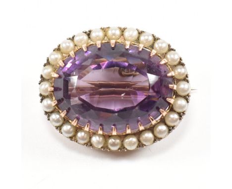 An early 20th century gold and amethyst brooch pin. The brooch set with a large oval cut amethyst framed by simulated pearls 