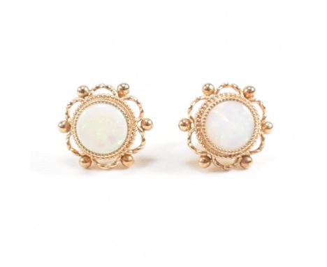 A pair of hallmarked 9ct gold and opal ear studs. Weight 2.3g. Measures head approx 9mm.&nbsp;All weights measurements and si