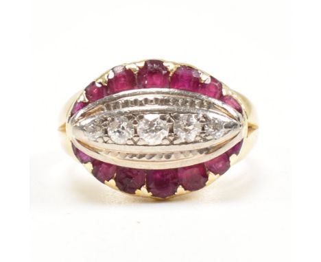 A 1930s 18ct gold ruby and diamond ring. The ring set with a central row of old cut diamonds framed by rubies. Partial marks 