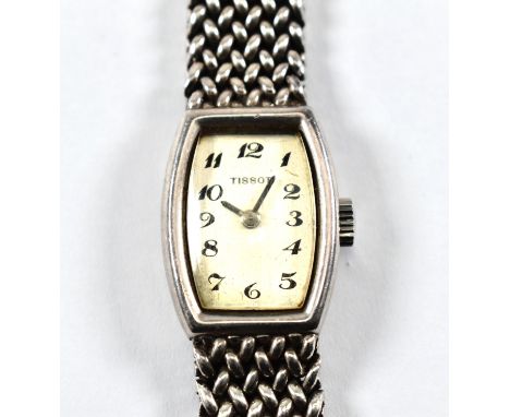 A vintage hallmarked silver Tissot wristwatch. The watch on silver mesh strap. The interior of the watch case marked 1061 792