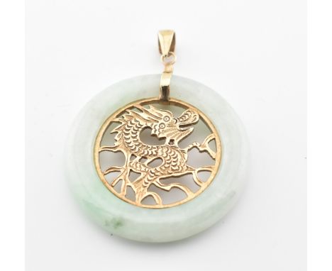 A Chinese 9ct gold and jade pendant. The jade roundel inset with a pierced panel depicting a Dragon. Stamped 375 to the bale.