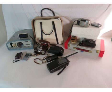 A slide projector and a collection of slides, various cameras and other items.