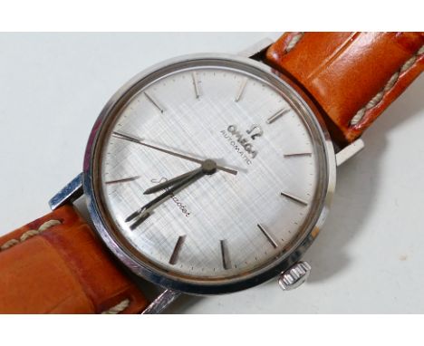 A vintage Omega Seamaster stainless steel cased automatic wrist watch, baton markers to a silvered dial, 34 mm (d) case on la