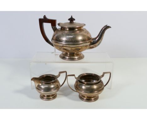 A George V three piece silver tea service comprising teapot, sugar bowl and milk jug, Sheffield assay 1912, sponsors mark for