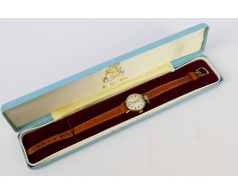 A 9ct gold cased Rotary wrist watch on brown leather strap. [W]