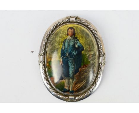 A vintage sterling silver brooch set with an oval panel bearing an image of the Blue Boy marked 'after Gainsborough', approx 