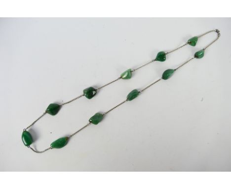 A jade necklace on white metal chain, approx 72 cm