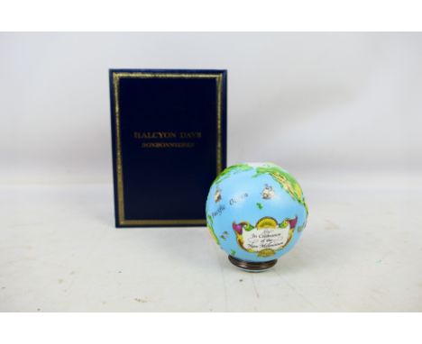 A boxed Halcyon Days enamel globe, celebrating the new millennium. [W]Condition Report: Some surface scratching and dirt in a