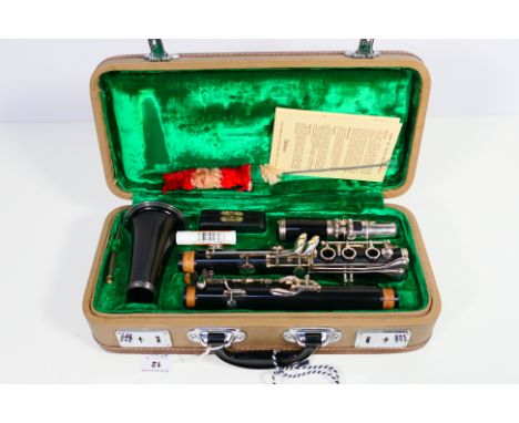 A steel ebonite clarinet with accessories and guarantee card, contained in fitted case with Selmer instruction book. [W]