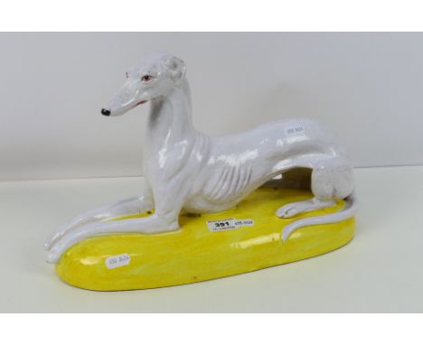 A large Italian majolica study of a recumbent greyhound, approximately 38 cm (l). [W]Condition Report: Appears in good condit