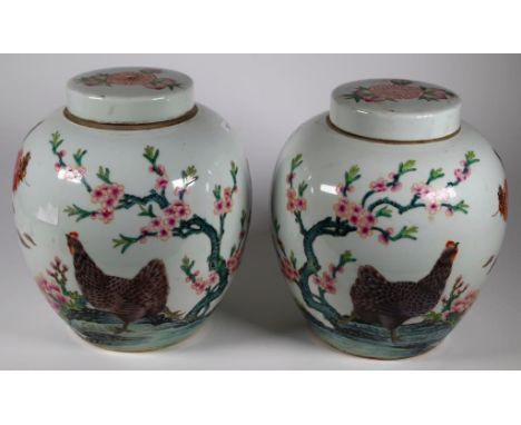 Pair Chinese lidded  ceramic jars each with painted cockerel decoration, and script verso, character marks to base. (Height 2