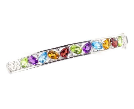 Multi gemstone and sterling silver bangle set with peridot, topaz, citrine, garnet, amethyst. Approx 62mm inside width. Hinge