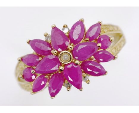 10ct gold ruby and diamond cluster ring marked 10k approx weight 3.18 grams, ring size R-S.Tests as 9ct. Rubies showing signs