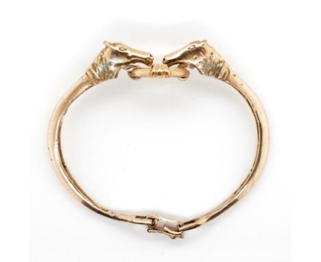 A gilt horse and snaffle bit bangle unmarked. Approx 27.4 grams weight, 56mm inside width. Tests as silver gilt