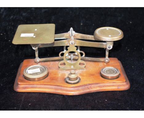 Vintage pair brass postage scales on wood base, together with 4 brass weights.