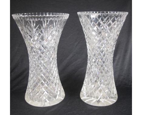 Two vintage cut crystal tall vases a near pair of waisted centrepiece vases. (Rim chips to 1).  (Height 36cm approx, each).