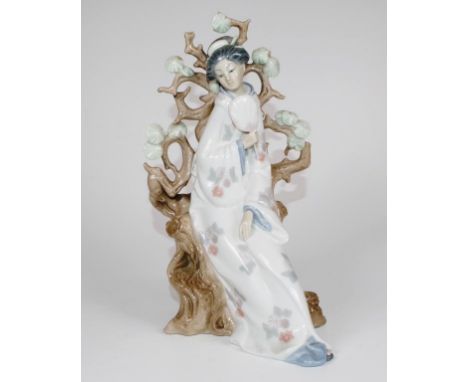 Lladro seated Chinese woman figure woman in traditional dress, holding a fan, seated on a flowering shrub. Marked to base, (H